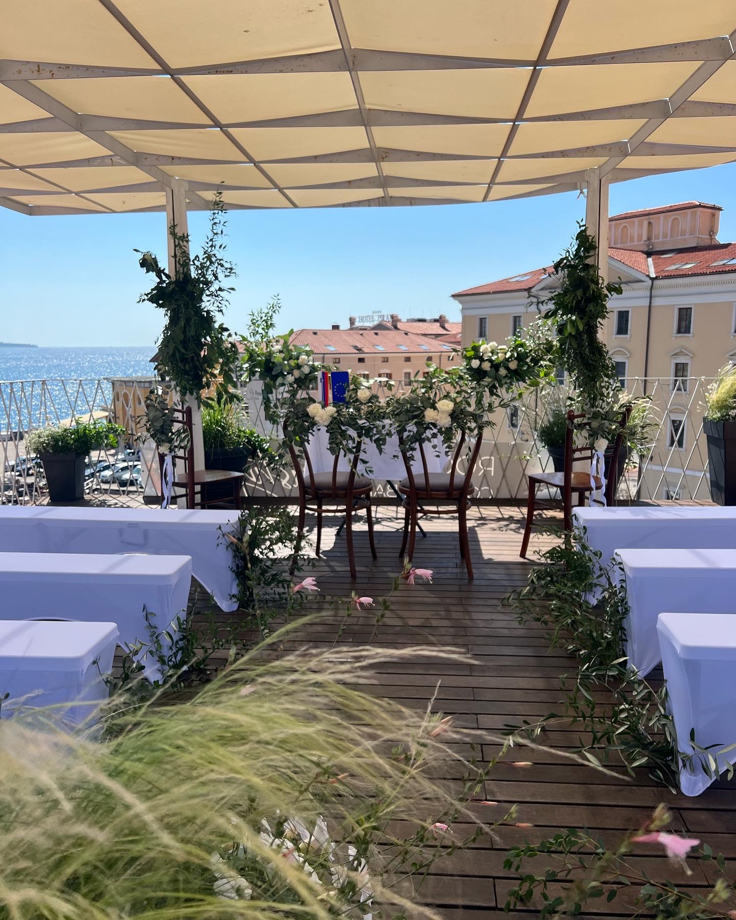 A wedding ceremony set up on the rooftop terrace at golden hour